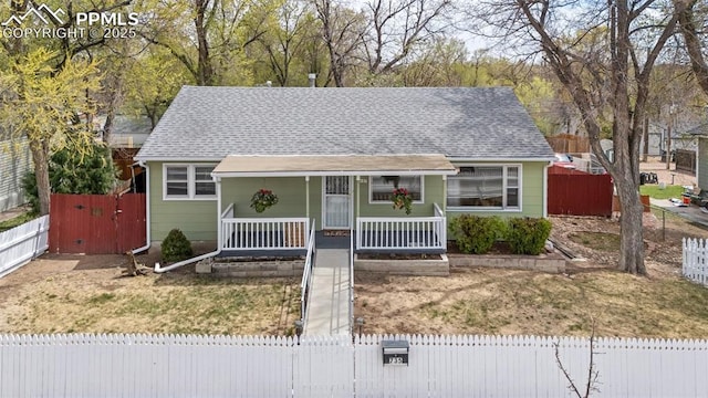 735 N Walnut St, Colorado Springs, CO 80905 - view of front of property featuring a porch, a gate, fence private yard, and a shingled roof