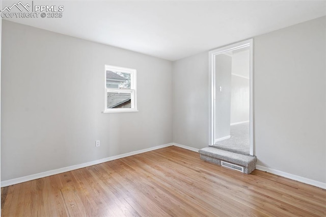 735 N Walnut St, Colorado Springs, CO 80905 - spare room with baseboards, wood finished floors, and visible vents