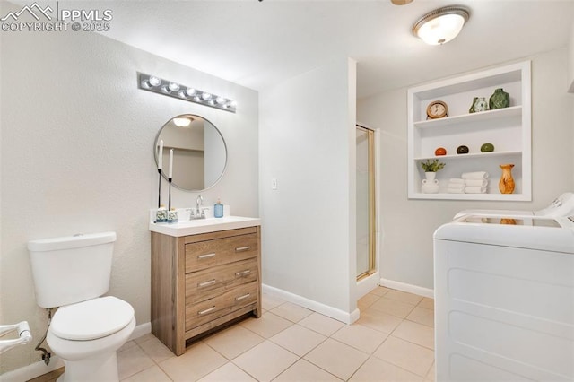 735 N Walnut St, Colorado Springs, CO 80905 - bathroom with vanity, toilet, tile patterned floors, a shower stall, and separate washer and dryer