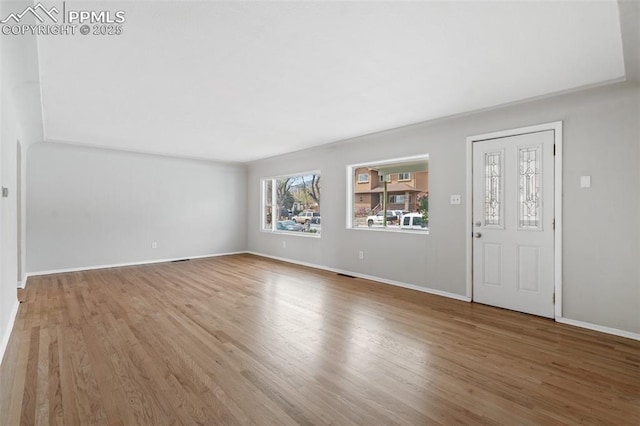 735 N Walnut St, Colorado Springs, CO 80905 - unfurnished living room with baseboards, visible vents, and wood finished floors