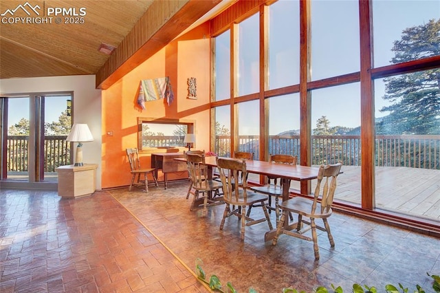 dining space with wooden ceiling and high vaulted ceiling