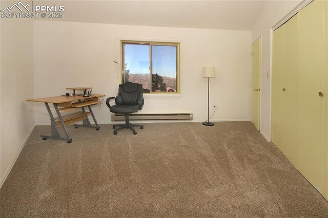 carpeted office space with a baseboard heating unit and baseboards