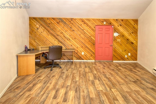 office area featuring baseboards, wood walls, and wood finished floors