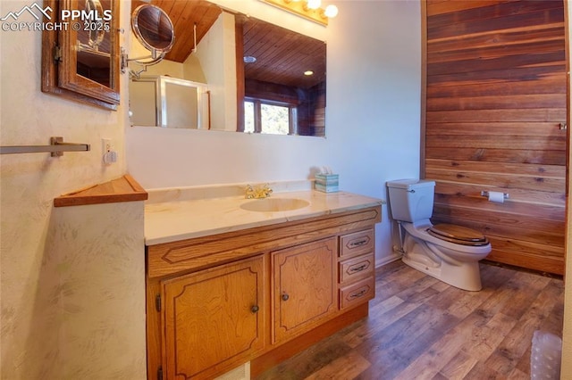 bathroom with wood finished floors, an enclosed shower, toilet, vanity, and wooden ceiling