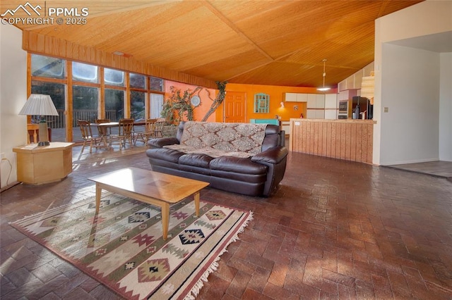 living area with lofted ceiling and wood ceiling