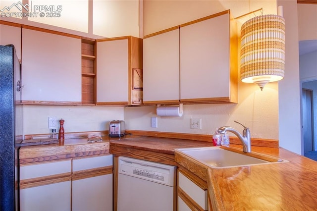 kitchen with a sink, freestanding refrigerator, white cabinetry, white dishwasher, and open shelves