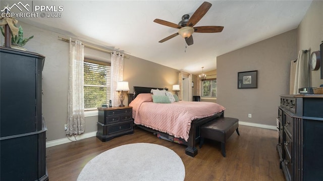 17770 Radbourne Ct, Monument, CO 80132 - bedroom with wood finished floors, multiple windows, vaulted ceiling, a ceiling fan, and baseboards