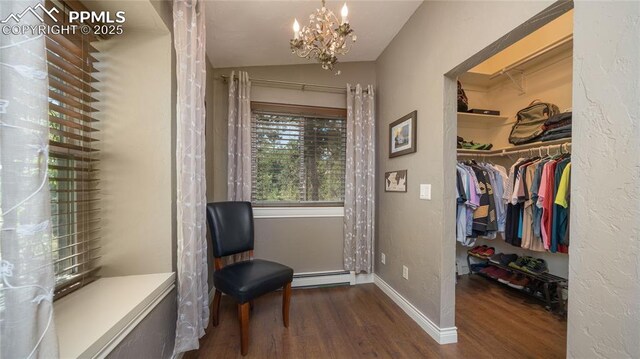 17770 Radbourne Ct, Monument, CO 80132 - living area with a baseboard heating unit, dark wood-style floors, a chandelier, lofted ceiling, and baseboards