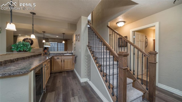 17770 Radbourne Ct, Monument, CO 80132 - stairs with wood finished floors, beverage cooler, and baseboards
