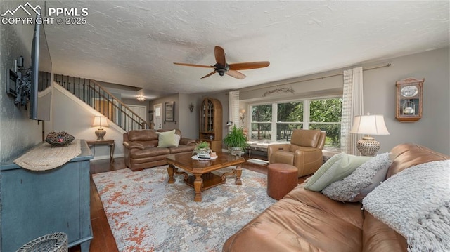 17770 Radbourne Ct, Monument, CO 80132 - living area featuring wood finished floors, a ceiling fan, stairway, and a textured ceiling