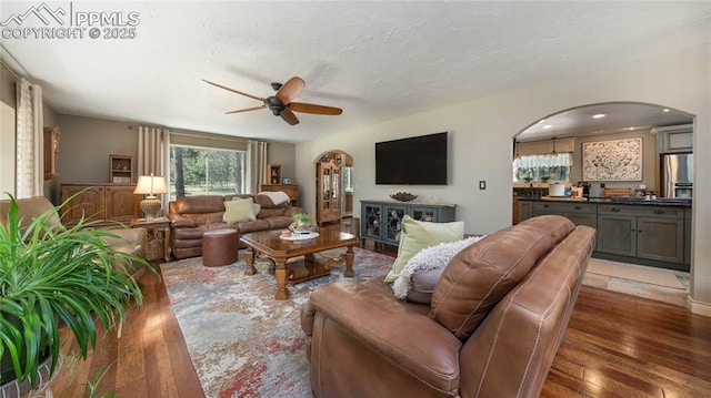 17770 Radbourne Ct, Monument, CO 80132 - living area with arched walkways, wood-type flooring, and a ceiling fan