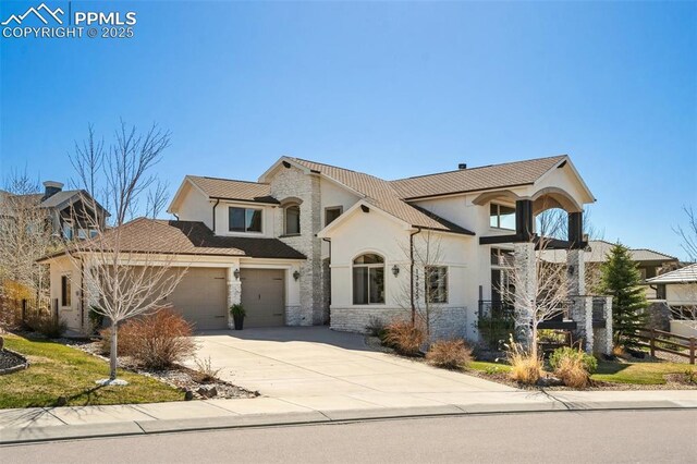 13625 Kitty Joe Ct, Colorado Springs, CO 80921 - view of front of property featuring fence, stucco siding, concrete driveway, stone siding, and a garage
