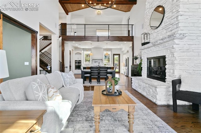 13625 Kitty Joe Ct, Colorado Springs, CO 80921 - living room with a fireplace, wood finished floors, and high vaulted ceiling