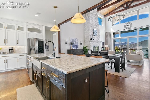 13625 Kitty Joe Ct, Colorado Springs, CO 80921 - kitchen featuring white cabinetry, beam ceiling, stainless steel appliances, and a sink