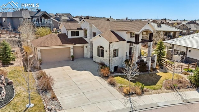 13625 Kitty Joe Ct, Colorado Springs, CO 80921 - french country style house with concrete driveway, stone siding, an attached garage, stucco siding, and a residential view