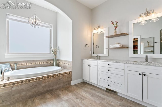 13625 Kitty Joe Ct, Colorado Springs, CO 80921 - bathroom featuring a garden tub, visible vents, a sink, and double vanity