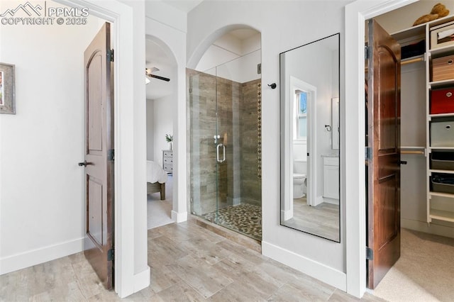 13625 Kitty Joe Ct, Colorado Springs, CO 80921 - bathroom with connected bathroom, a shower stall, toilet, and baseboards