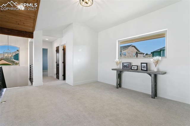 13625 Kitty Joe Ct, Colorado Springs, CO 80921 - hall featuring an upstairs landing, vaulted ceiling, carpet, and a notable chandelier