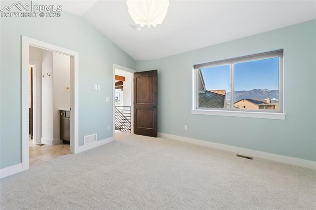 13625 Kitty Joe Ct, Colorado Springs, CO 80921 - unfurnished bedroom featuring vaulted ceiling, visible vents, carpet floors, and multiple windows