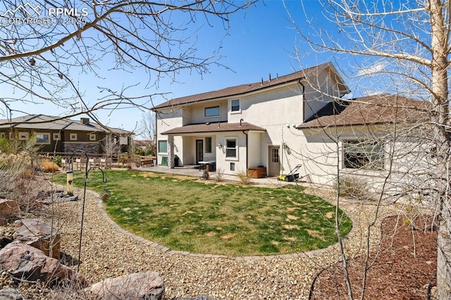 13625 Kitty Joe Ct, Colorado Springs, CO 80921 - rear view of house featuring stucco siding, a patio area, a yard, and a shingled roof