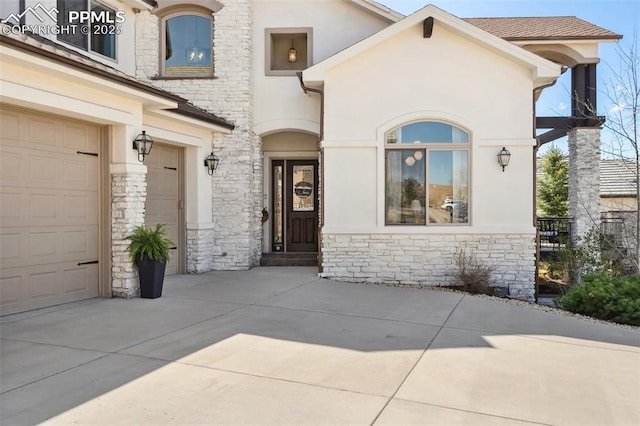 13625 Kitty Joe Ct, Colorado Springs, CO 80921 - view of exterior entry featuring stucco siding, stone siding, and concrete driveway