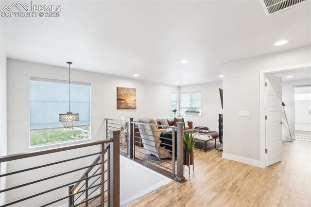 interior space featuring recessed lighting, a notable chandelier, light wood-type flooring, and visible vents
