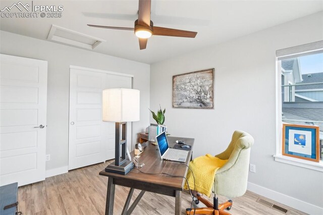 office area with visible vents, wood finished floors, baseboards, attic access, and a ceiling fan