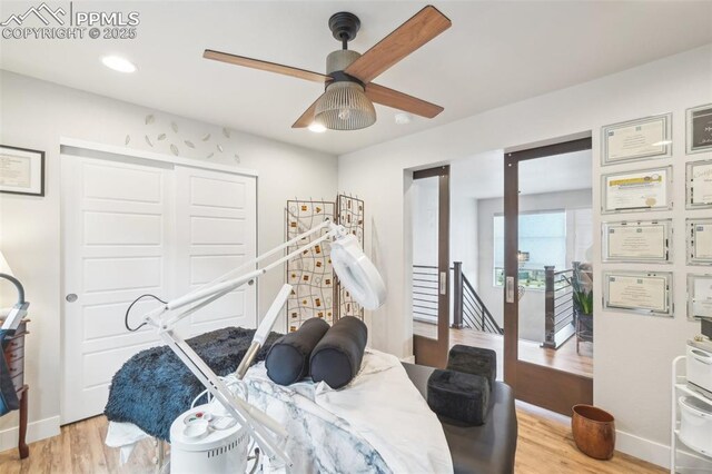 bedroom featuring recessed lighting, ceiling fan, light wood-style flooring, and a closet