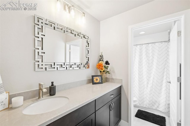 bathroom featuring toilet, a shower with curtain, and vanity