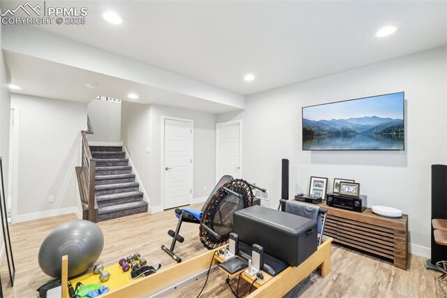 exercise room featuring baseboards, recessed lighting, and wood finished floors
