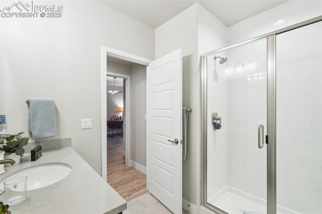 full bath with vanity and a shower stall