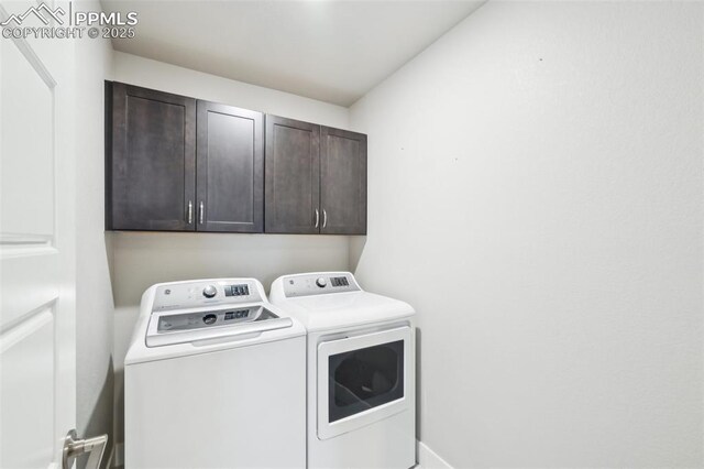 washroom featuring cabinet space and independent washer and dryer