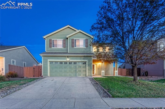 traditional-style house featuring an attached garage, a front lawn, fence, and driveway