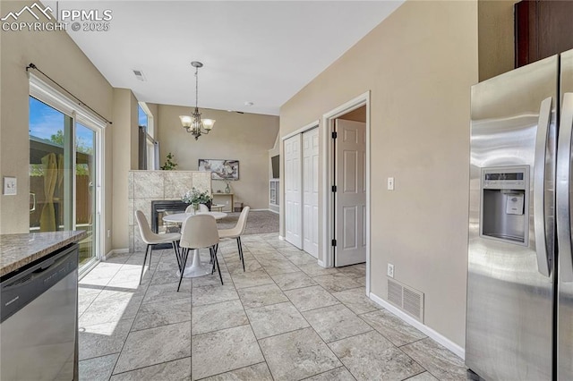 dining room featuring baseboards, visible vents, and a chandelier