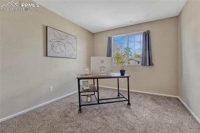carpeted office featuring visible vents and baseboards