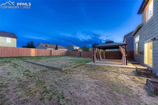 view of yard featuring a gazebo, a fenced backyard, and a patio area