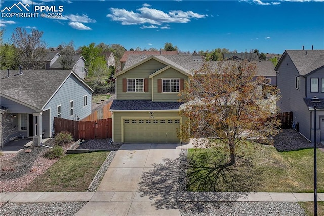 traditional home with fence, an attached garage, concrete driveway, and a residential view