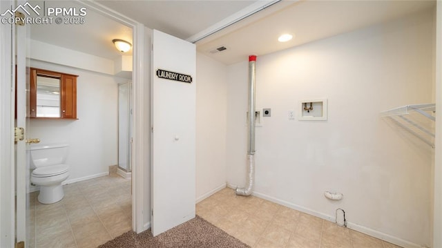 laundry area with hookup for an electric dryer, washer hookup, and baseboards