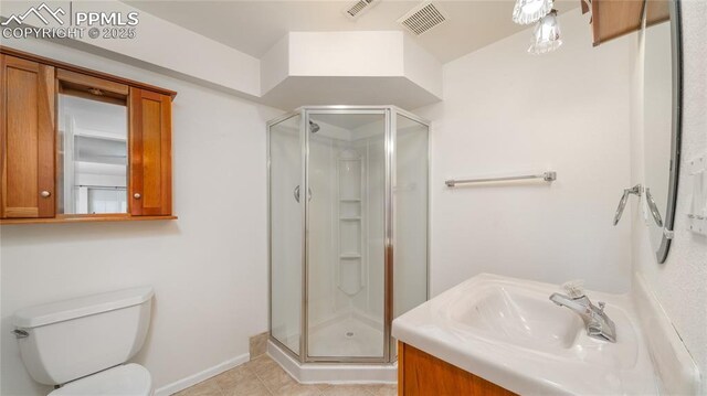 bathroom with a stall shower, toilet, tile patterned floors, and vanity