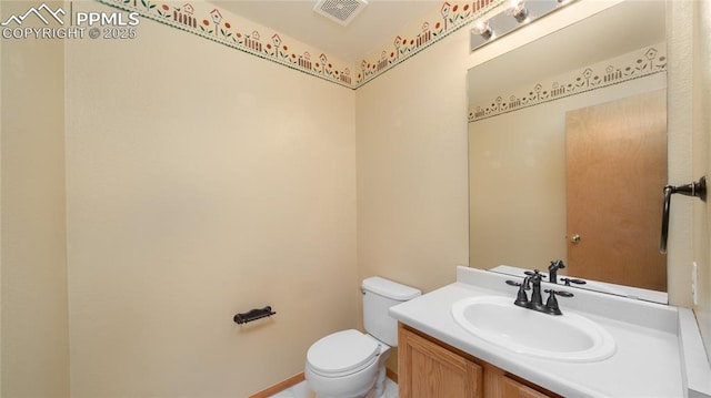 bathroom with toilet and vanity