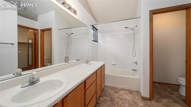 full bathroom featuring toilet, double vanity,  shower combination, and baseboards