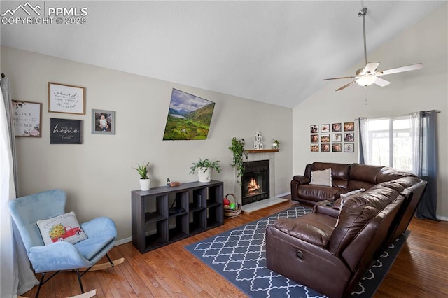 537 Blossom Field Rd, Fountain, CO 80817 - living room featuring baseboards, a ceiling fan, wood finished floors, a tile fireplace, and high vaulted ceiling