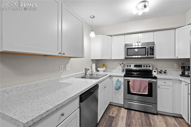 537 Blossom Field Rd, Fountain, CO 80817 - kitchen featuring white cabinets, stainless steel appliances, dark wood-type flooring, and a sink