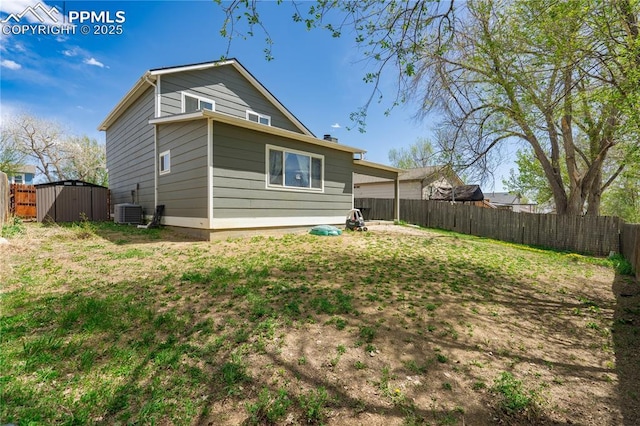 537 Blossom Field Rd, Fountain, CO 80817 - back of house with a storage shed, cooling unit, an outbuilding, and a fenced backyard