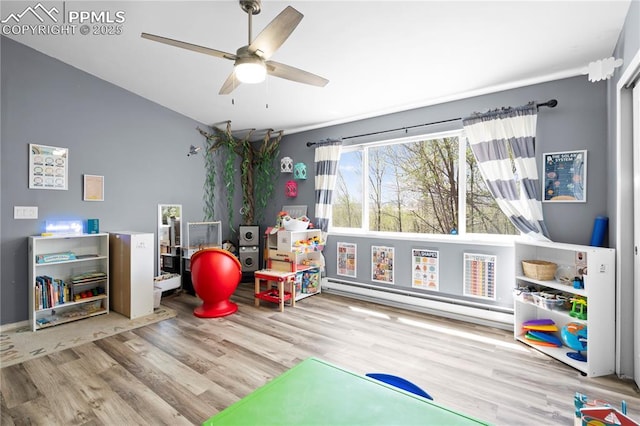 537 Blossom Field Rd, Fountain, CO 80817 - playroom featuring vaulted ceiling, wood finished floors, baseboard heating, and ceiling fan