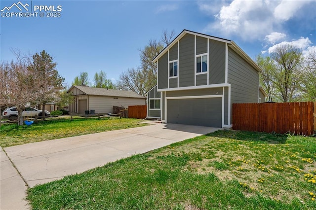 537 Blossom Field Rd, Fountain, CO 80817 - traditional-style home with fence, an attached garage, a front lawn, and concrete driveway