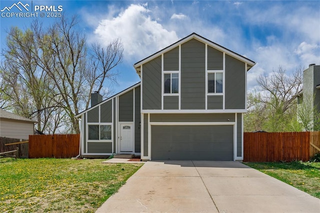 537 Blossom Field Rd, Fountain, CO 80817 - view of front of home with concrete driveway, a chimney, a front lawn, an attached garage, and fence