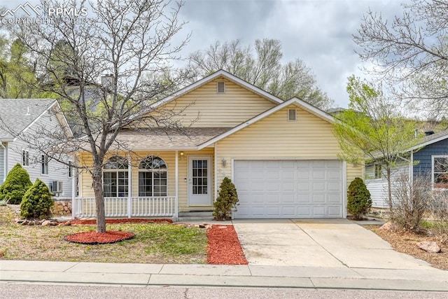ranch-style home featuring a porch, a shingled roof, concrete driveway, and a garage