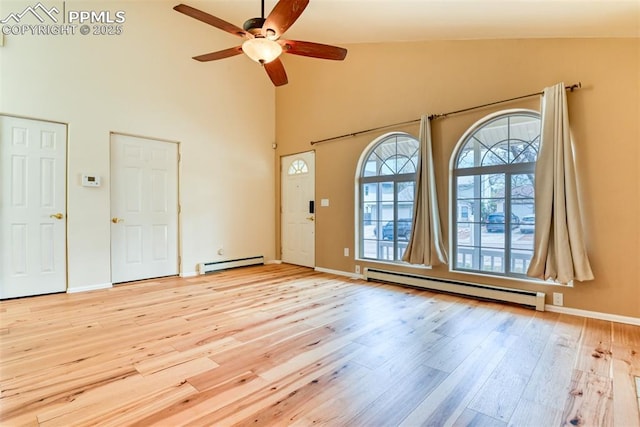 interior space with a ceiling fan, baseboard heating, a baseboard radiator, light wood-style flooring, and high vaulted ceiling