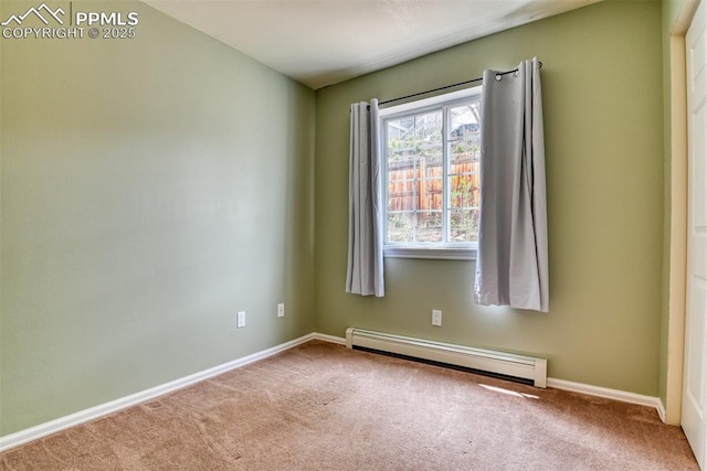 empty room with a baseboard radiator, baseboards, and carpet